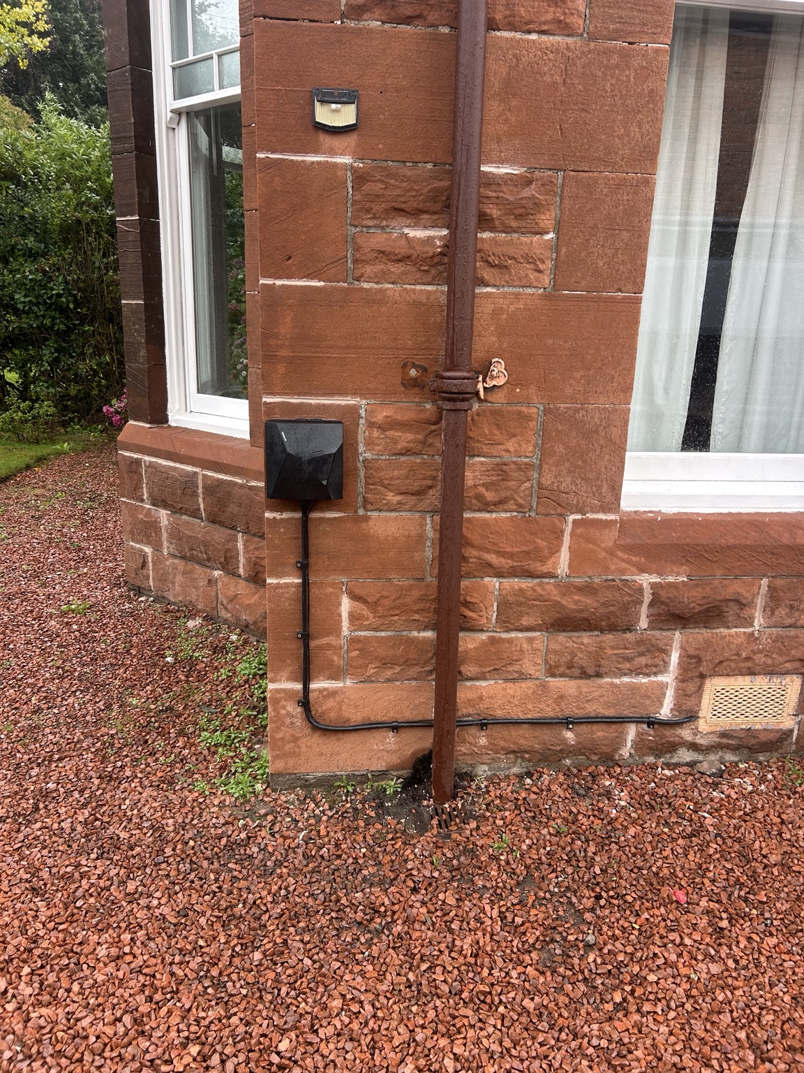 EV charger installed on a red sandstone home in Glasgow by EG3 Electrical